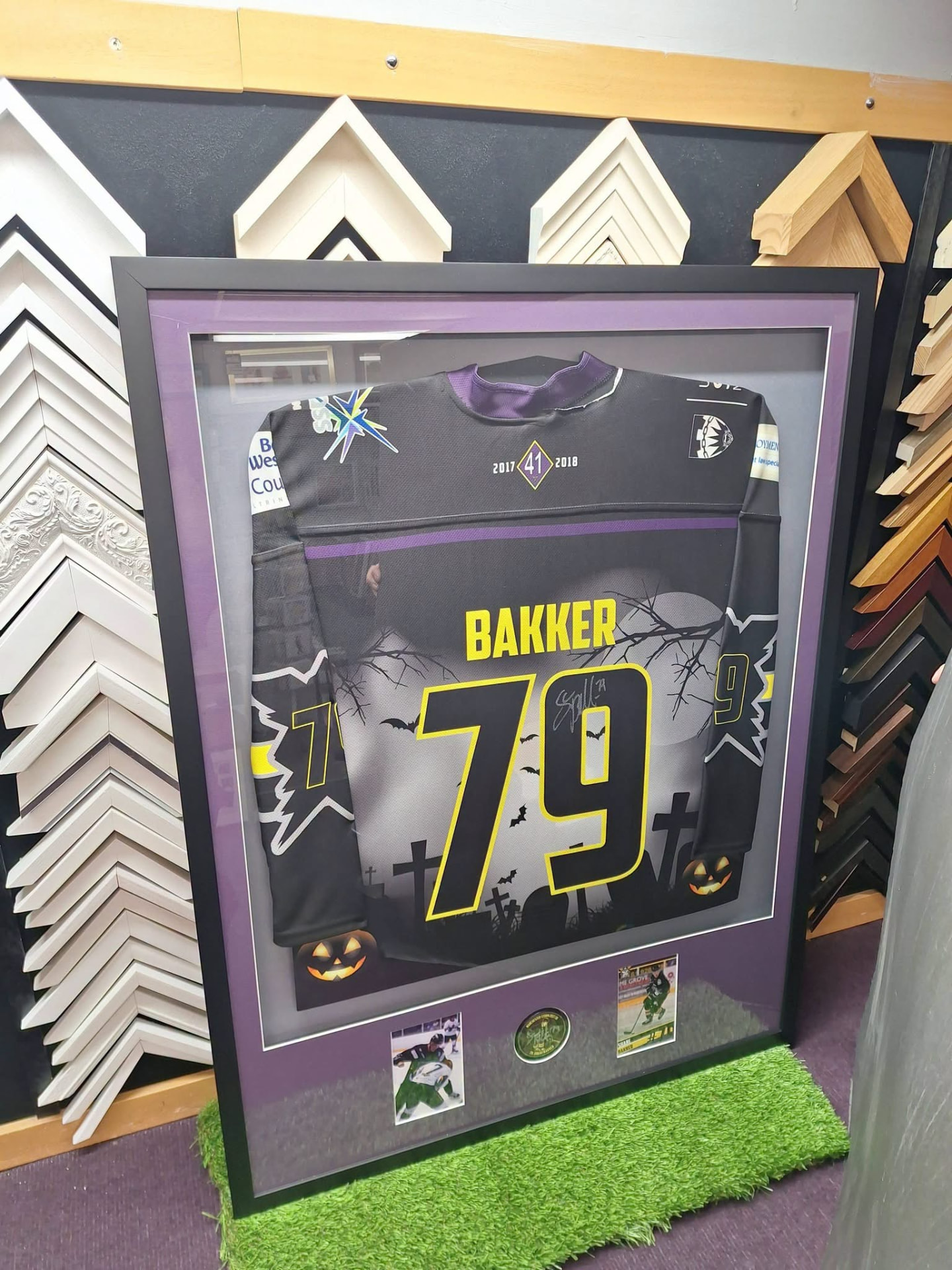 Ice hockey jersey in a deep box frame with dark wood moulding