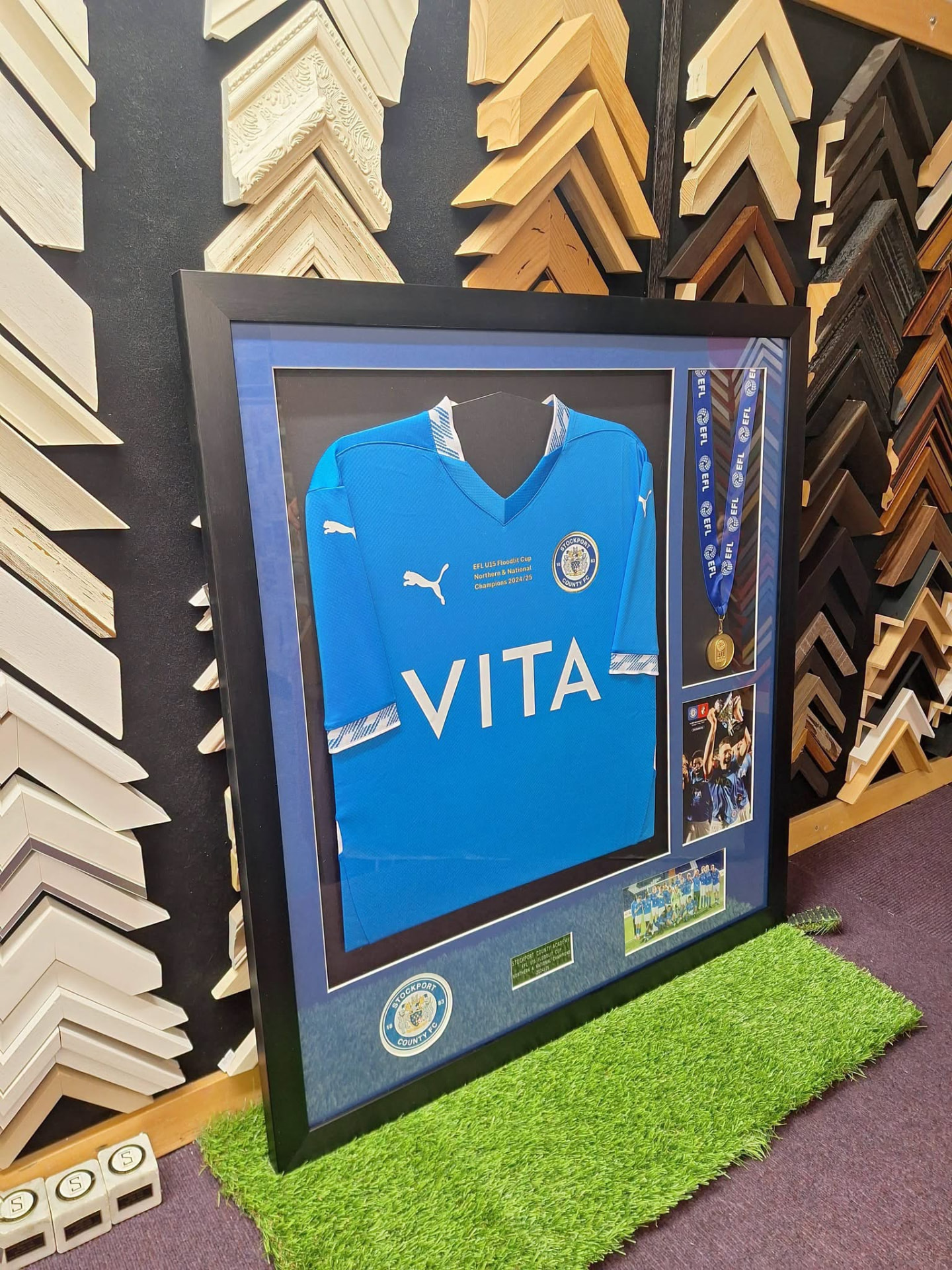 Shirt framed with medal and photographs