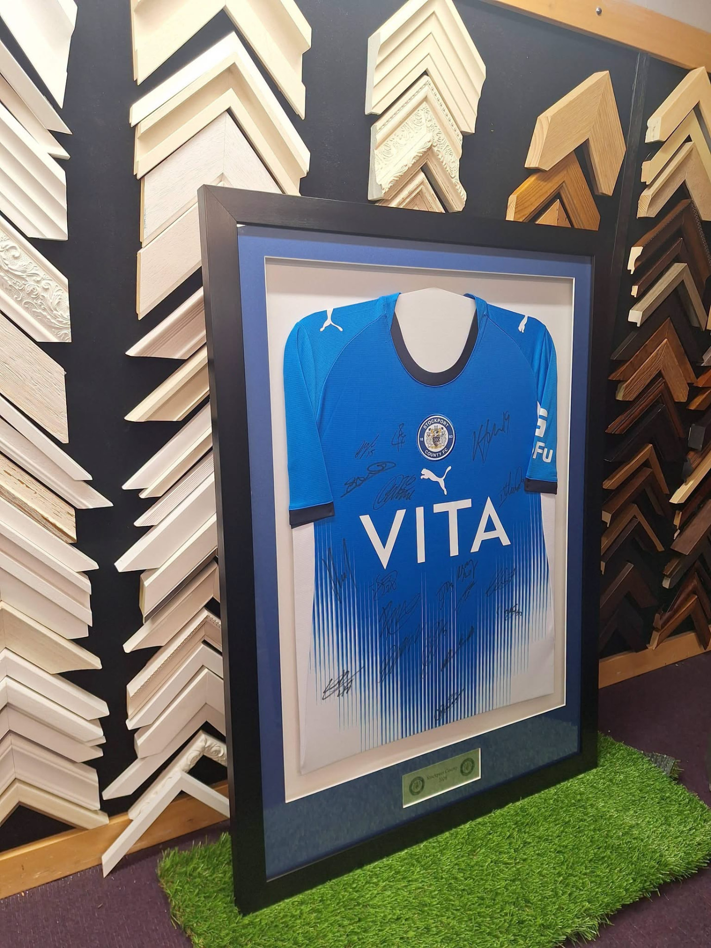 Signed Stockport County shirt in a black frame with blue mount